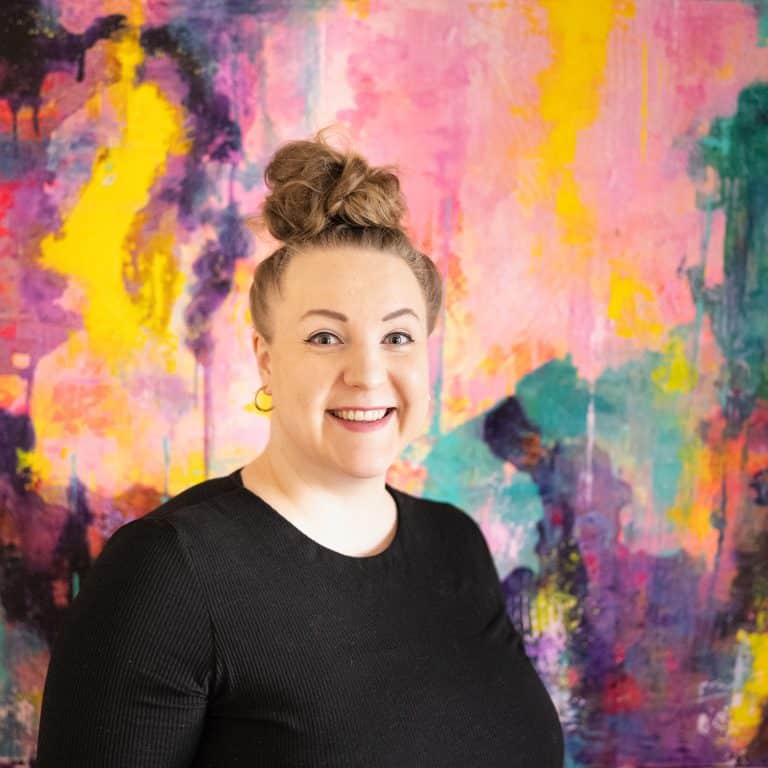 Matilda Kääntä oma kuva ja hänen tekemä iso abstrakti teos taustalla